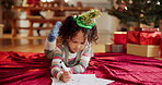 Christmas, child and paper in home for drawing, letter and writing note to Santa. Young girl, stationery and picture on floor for creativity, gift request and DIY greeting card for festive season