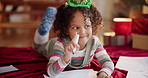 Christmas, kid and thinking in home with paper, drawing and writing note to Santa. Young girl, idea and picture on floor for creativity, gift brainstorming and DIY greeting card for festive season