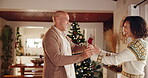 Couple, home and smile with dancing on Christmas for fun, break and celebration as lovers. Relationship, people and happy with bonding in living room on festive season for unity, love and support