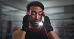 Face, hands and headache with boxer man in gym for exercise, fitness or training routine. Agony, discomfort and migraine with sports person massaging head in health club for physical workout closeup