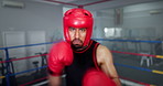 Boxing, punch and face of man in gym with helmet, energy and champion athlete training for competition. Gloves, hit and pov of speed boxer in ring with fitness, exercise or knockout at fight club