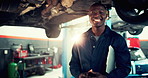 Mechanic, face and checklist with black man and car in auto repair shop for diagnostic system, transport or calibration. Engineering, maintenance or motor technician with portrait of person in garage
