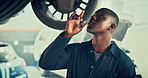 Mechanic, inspection and workshop with black man and car in auto repair shop for diagnostic system, transport or calibration. Engineering, maintenance or motor technician with person in garage