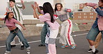 Dancing, group and dancers on bridge in city with hip hop routine practicing for flash mob. Happy, freedom and people with freestyle, groove or choreography in street with rhythm in urban town.