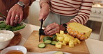Cooking, food and hands of couple in kitchen together to prepare meal for diet, health or nutrition. Ingredients, recipe or wellness with people cutting cucumber and pineapple for salad in apartment
