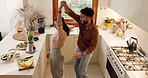 Happy, couple and dancing in kitchen with food or ingredients for meal prep with fun. People, home and smile as lovers in relationship with fruit for juice or smoothie in bonding, support and caring