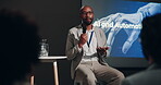 Talking, seminar and man with mic, audience and discussion of Ai and automation on stage and presentation. Workshop, public speaking and explaining to people, event and ethics for system and industry