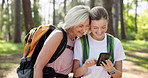 Happy woman, mother and phone in travel, sightseeing or adventure in nature, park or forest. Smile, mature parent and tourist with smartphone for research, holiday or vacation in woods for bonding