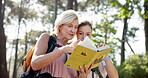 Explore, nature and daughter with book by woman for bird watching, information and reading travel guide. Mature mother, hike and binoculars with adventure in forest for holiday, manual and location