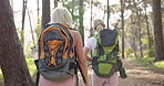 Mother, daughter and backpack for hiking with pointing in forest with fitness adventure, bonding or sightseeing. Mature woman, back or trekking in woods for cardio exercise, explore nature or walking