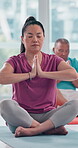 Calm, mature woman and meditation at gym for spiritual healing, mindfulness and awareness in retirement. Zen, person and relax with chakra balance exercise for holistic, inner peace and mental health