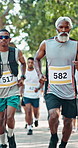 Running, nature and black men in marathon with group for outdoor exercise, competition or fitness. Sports, energy and African male athletes with cardio workout in race with crowd for contest in park.