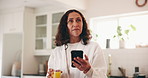 Juice, phone and thinking with woman in kitchen of home for app, social media or text message. Drink, glass and mobile with mature person in apartment to search for diet, health or nutrition info