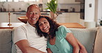Happy couple, relax and sofa with hug for bonding, comfort or love together on holiday or weekend at home. Mature, man and woman with smile in joy for embrace, free time or support on couch at house