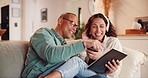 Tablet, discussion and couple in home living room on sofa, streaming funny video and bonding. Smartphone, laugh and happy man with woman and headphones for social media research or internet browsing