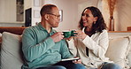 Tablet, coffee break and couple in home living room on sofa, streaming video and bonding. Technology, toast and happy man with woman and networking for social media research or internet browsing