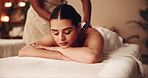 Woman, relax or bed with masseuse for back massage, zen or comfort at luxury indoor spa. Young, female person or sleeping with physical therapy for calming sensation, stress relief or salon treatment