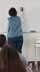 Presentation, education and classroom as teacher in writing on whiteboard for growth or development. Female person, study methods and assessment for course or module with knowledge, students or exam