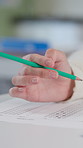 Hands, anxiety and student with test in classroom at school for scholarship admission question paper. Education, learning and closeup of person studying with practice exam, assignment or project.