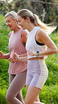 Mature mom, daughter and smile for fitness outdoor with running, walking and bonding. People, parent and happy on vertical in forest with laughing, support and trust with love for health and wellness