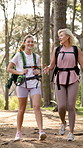 Nature, hiking and woman with senior mother in forest for exploring, adventure or trekking. Laughing, walking and female person with elderly mom backpacking outdoor in woods for exercise together.