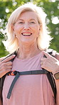 Happy, backpacking and face of senior woman in nature for fitness, adventure or exploring. Laughing, travel and portrait of elderly female person from Switzerland hiking outdoor in forest or woods.