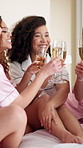 Cheers, champagne and bride with friends in bedroom for getting ready for marriage ceremony. Happy, alcohol drink and woman with bridesmaids with sparkling wine for toast at wedding location together