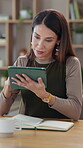Business, notebook and tablet with mature woman at desk in office for administration or research. Information, planning and technology with professional employee in workplace for design feedback