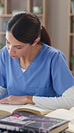 Healthcare, books and nurse in clinic with research for diagnosis or treatment plan for surgery. Information, reading and medical worker writing notes for preparing for consultation in hospital.