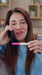 Woman, home and happy in phone call with pregnancy test for good news, positive results and communication. Female person, apartment and smile or excited with ivf success, fertility or family planning