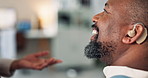 Healthcare, hands and doctor with hearing aid, man and listening in modern office. Closeup, medical and nurse with implant for patient, communication support and person with disability, smile or help