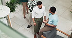 Collaboration, conversation and tablet with business men in lobby of office together for planning from above. Meeting, teamwork and technology with employee people in workplace for web development