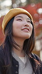 Thinking, smile and Japanese woman outdoor with wind in hair on holiday, vacation or view to relax with vision. Dream, inspiration and Asian girl in nature for tourism, adventure or planning future