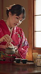 Japanese, woman and tea ceremony with student, culture and tatami room for hospitality and ritual. Harmony, hot drink and learning about Japan tradition, mindfulness and zen Buddhism practice 