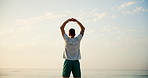 Man, yoga and stretching with back on beach for breathing exercise, fitness or outdoor workout in nature. Male person, yogi or zen with warm up or sky for balance, health and wellness on ocean coast