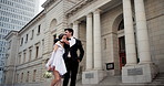 Couple, wedding and hug in street, walk and city by courthouse with suit, gown and love with kiss. People, bride and groom with embrace, marriage and celebration with commitment for future in Spain