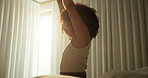 Girl, wake up and stretching on bed in home with morning routine or feeling fresh of sleeping. Woman, person or arm movement in bedroom for start day, energy or wellness of break, resting and sunrise