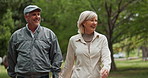 Senior, happy couple and holding hands with love in nature for bonding, walk or old romance at outdoor park. Mature, man or woman with smile in forest or woods for travel, care or support together