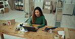 Distribution, laptop and zoom with business woman at desk in depot for delivery tracking. Computer, logistics and supply chain with happy African employee at work for online shopping or retail