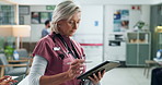 Woman, doctor and typing with tablet in hospital for healthcare services, medical advice and about us. Mature, surgeon and check information for treatment, diagnosis and research with report results