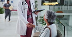 Mature woman, doctor and tablet for medical services, appointment or consultation with professional. Female people, handshake and conversation with tech for checkup, visit or examination in hospital