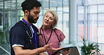 Tablet, team and surgeon with nurse for planning, discussion and mature doctor to help intern in hospital. Technology, medical people and collaboration for wellness research, meeting and healthcare
