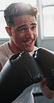 Fitness, boxing and man in gym with punching for exercise, challenge or competition training. Power, muscle development and champion boxer in workout with sweat, fight and energy in sports club