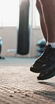 Legs, jumping and man with fitness, rope and training with health, challenge and endurance. Closeup, sneakers and athlete in wellness center, cardio and resilience with shoes, workout routine in gym