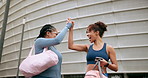 Women, happy and high five with mobile phone for teamwork, fitness and pilates training in city. Female people, excited and technology for successful workout, sports or physical activity in gym class