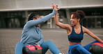 High five, workout and happy women in city with medicine ball, outdoor and wellness on ground. Weight training, friends and athlete with fitness, exercise and rest with motivation, success and smile