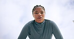 Black woman, sweat and face in recovery for outdoor workout, exercise and wellness as tired. Female person, portrait and below as athlete for health, challenge and training for fitness or sport in UK