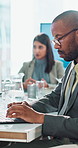 Business, man and listening in meeting with laptop for typing minutes, budget conference or financial summary. Finance administrator, team or feedback on proposal review and company investment update