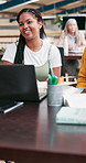 Diversity, laptop and creative people brainstorming, planning and conversation for group project in office. Women, problem solving and discussion for research, goals and talking in coworking space