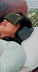 Woman, headphones and psilocybin therapy on sofa with cushion blindfold for treatment of anxiety or depression. Mental health, patient and counseling with natural medicine, micro-dosing and audio